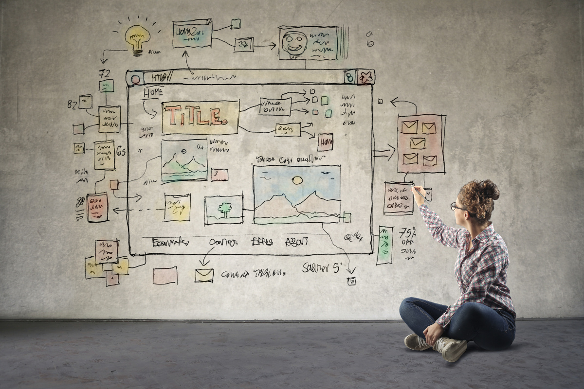 Young woman drawing web design on a bord